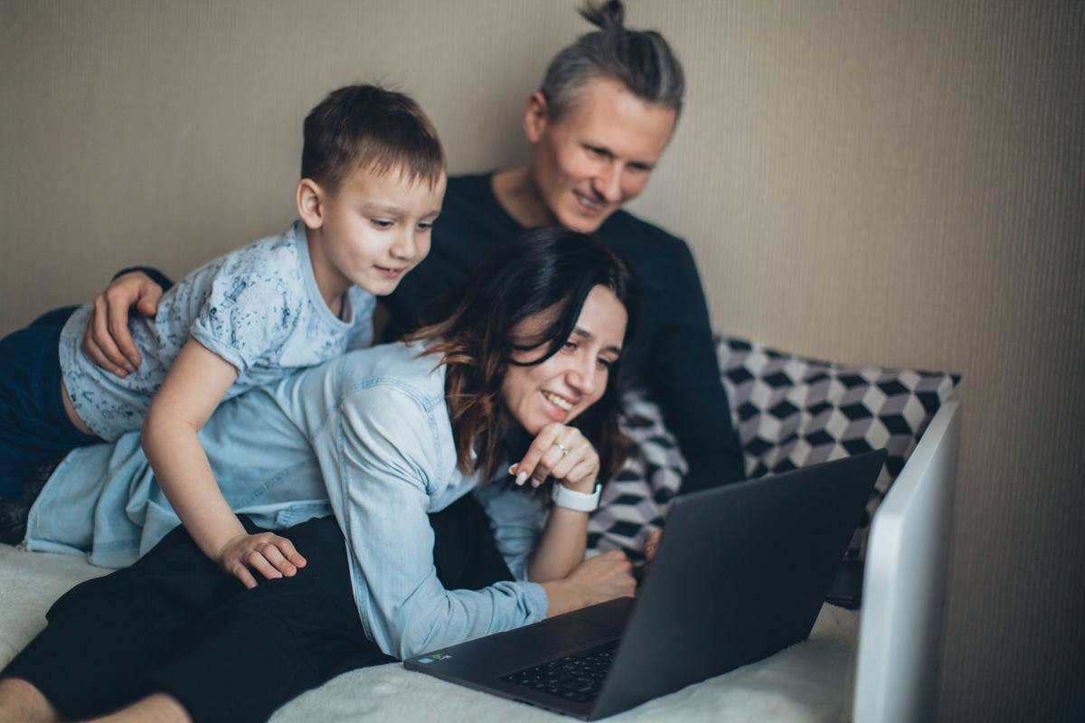 A family looking at a laptop together at home